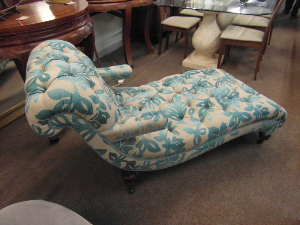 A Victorian upholstered chaise longue featuring deep-buttoned tufting in a teal and cream floral pattern with short turned wooden legs. View IV