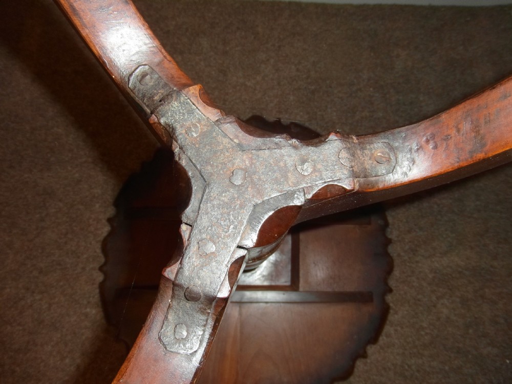 A circular dark mahogany side table featuring a carved pie-crust scalloped top supported on a turned central column and three cabriole tripod legs. View IV