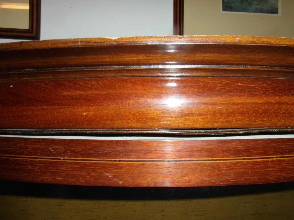 An Edwardian mahogany display cabinet featuring a bow-front glazed central section, side glass panels, interior shelves, and string inlay. View VI