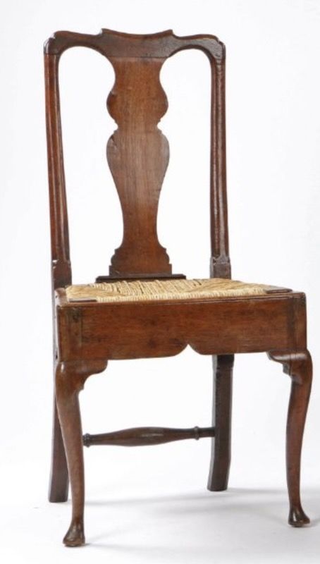 fig 1. A pair of antique Queen Anne oak side chairs featuring vase-shaped splat backs, woven rush seats, and cabriole front legs with pad feet.