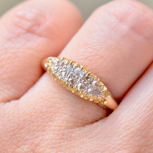 fig 1. A Victorian gold ring featuring a boat-shaped setting set with two rows of old mine cut diamonds.