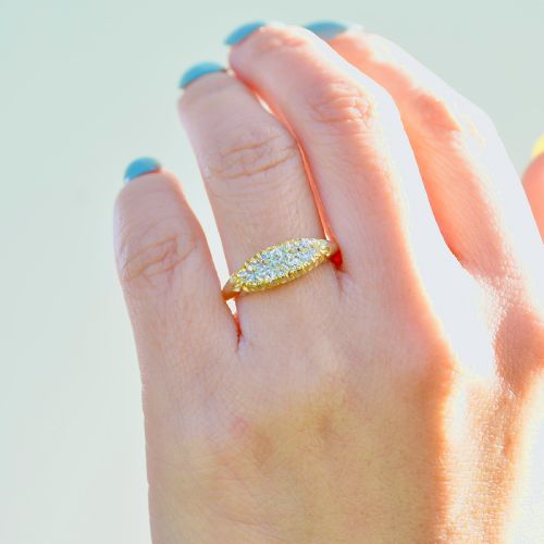 fig 5. A Victorian gold ring featuring a boat-shaped setting set with two rows of old mine cut diamonds.