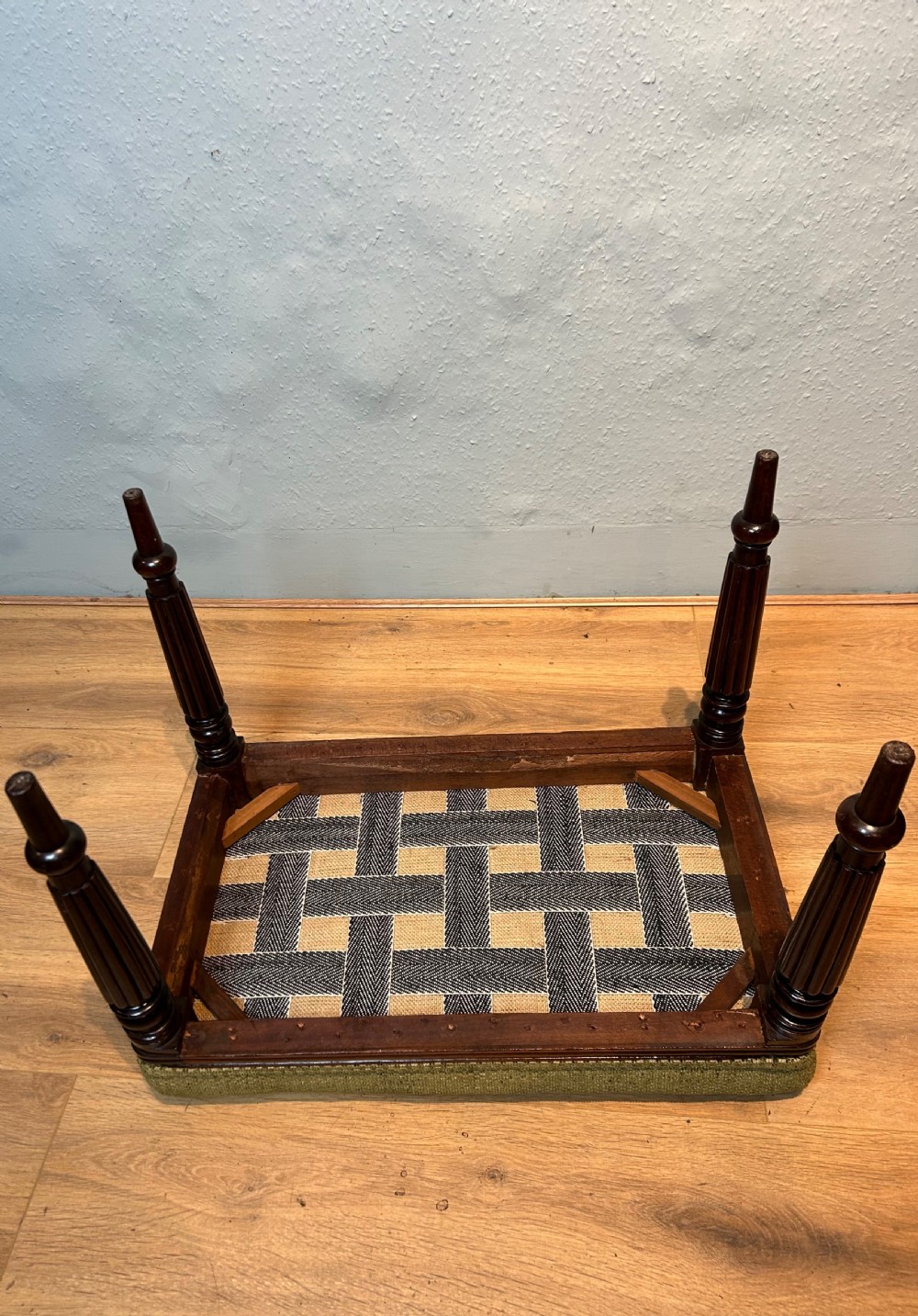 A rectangular Regency period mahogany stool featuring fluted turned legs and a green textured woven fabric cushion. View VIII