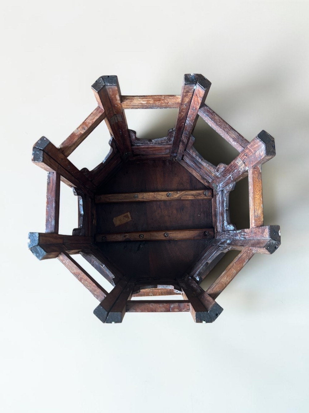 An octagonal wooden occasional table featuring dense white floral and geometric bone inlay across the top and arched panel legs. View VII