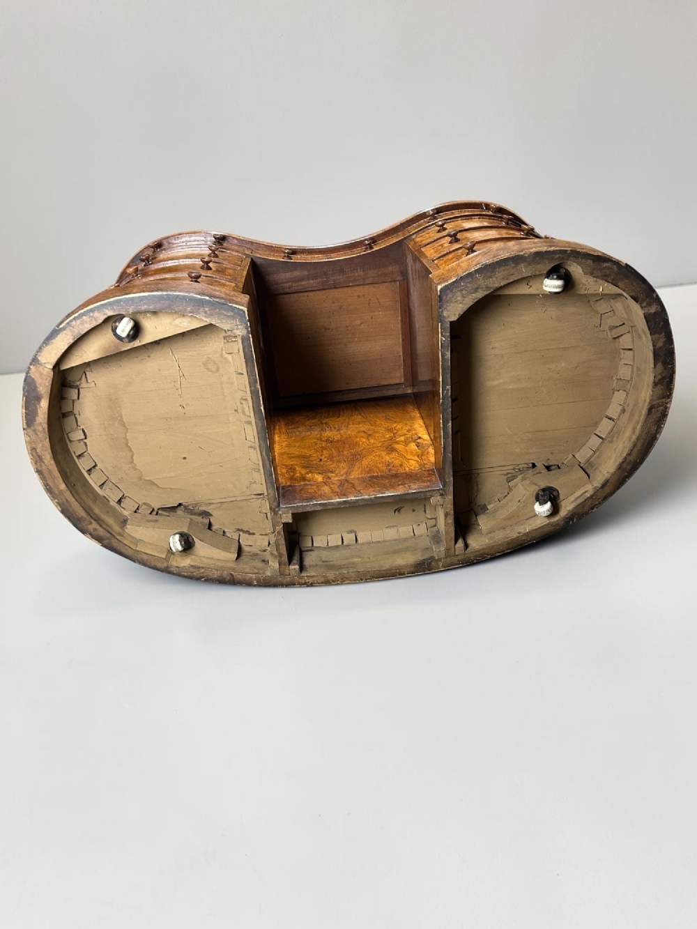 A 19th-century freestanding kidney-shaped desk crafted from warm brown burr walnut with a dark leather inset top and dual drawer pedestals. View X