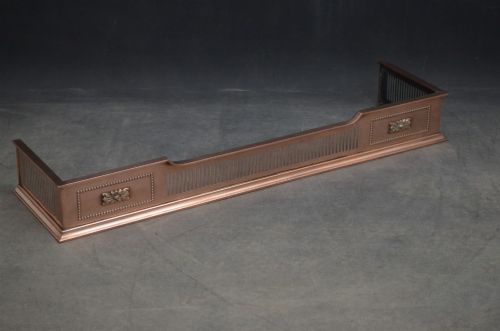 An antique Victorian copper fireplace fender featuring pierced vertical slots and side panels embellished with raised floral paterae and beaded edging. View III