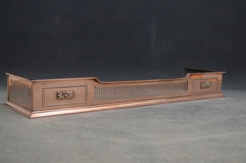 An antique Victorian copper fireplace fender featuring pierced vertical slots and side panels embellished with raised floral paterae and beaded edging. View IV