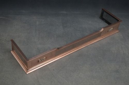 An antique Victorian copper fireplace fender featuring pierced vertical slots and side panels embellished with raised floral paterae and beaded edging. View V