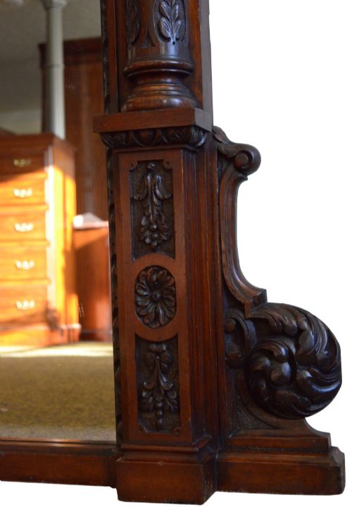 fig 2. A tall 19th-century English solid oak mirror featuring an arched top, fluted column sides, and detailed hand-carved woodwork.