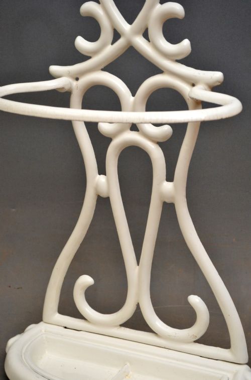 A white enamelled cast iron Art Nouveau umbrella stand featuring fluid scrollwork motifs and an integrated base drip tray. View IV
