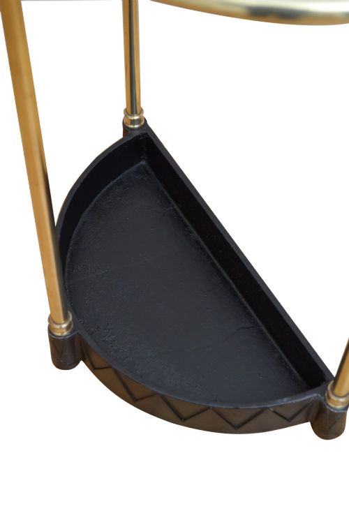 An Edwardian brass umbrella stand featuring a demi-lune frame, urn finials, three vertical posts, and a black cast iron drip tray with a dogtooth pattern. View VII