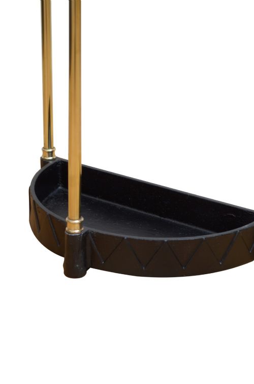 An Edwardian brass umbrella stand featuring a demi-lune frame, urn finials, three vertical posts, and a black cast iron drip tray with a dogtooth pattern. View IX