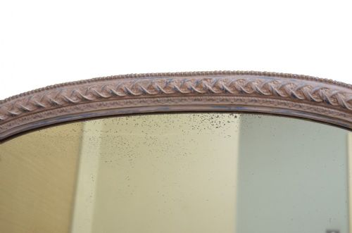 An arched French overmantel mirror featuring a carved wooden frame with a layered lilac and blue painted finish. View III