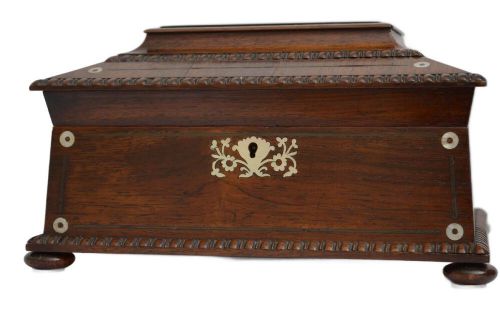 A William IV dark rosewood jewellery box featuring mother-of-pearl inlays, a tiered sarcophagus lid, carved gadrooned borders, and small bun feet. View XII