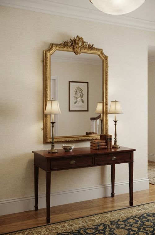 fig 1. A large nineteenth-century French giltwood overmantel mirror featuring an ornate carved cresting motif and a arched top rectangular frame.