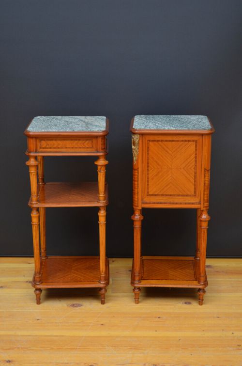 fig 1. A pair of antique satinwood bedside cabinets with green marble tops, fluted turned legs, and decorative parquetry wood inlays.