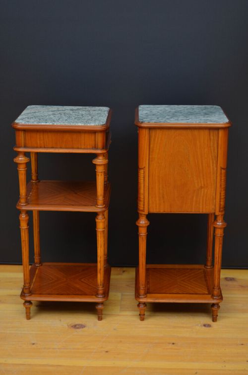 A pair of antique satinwood bedside cabinets with green marble tops, fluted turned legs, and decorative parquetry wood inlays. View V
