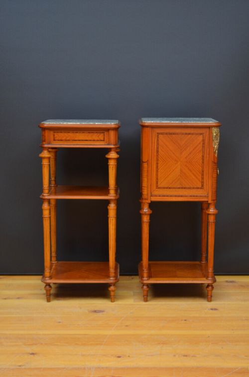 A pair of antique satinwood bedside cabinets with green marble tops, fluted turned legs, and decorative parquetry wood inlays. View VI
