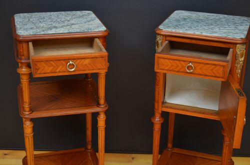 A pair of antique satinwood bedside cabinets with green marble tops, fluted turned legs, and decorative parquetry wood inlays. View XV