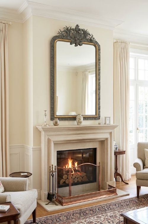 fig 1. A tall French Empire style pier mirror featuring a carved grey painted frame with an ornate acanthus crest and a gilded inner slip border.