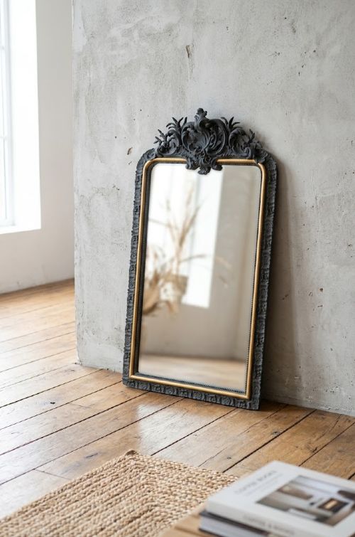 A tall French Empire style pier mirror featuring a carved grey painted frame with an ornate acanthus crest and a gilded inner slip border. View XV