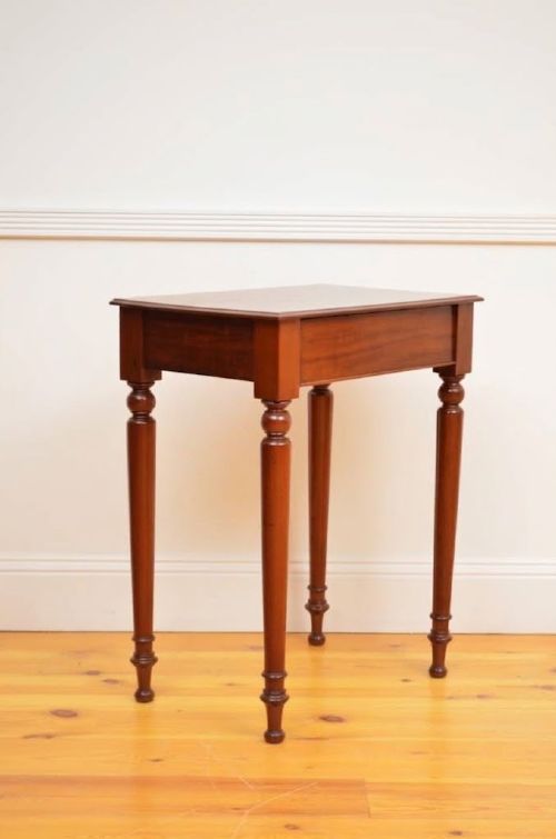 fig 1. A narrow antique mahogany console table featuring turned legs and a polished timber top against a plain white background.