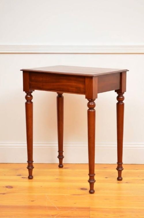 fig 2. A narrow antique mahogany console table featuring turned legs and a polished timber top against a plain white background.