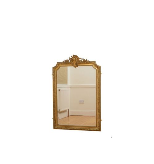 fig 1. A tall French giltwood wall mirror featuring a carved foliate crest and a moulded gold frame.
