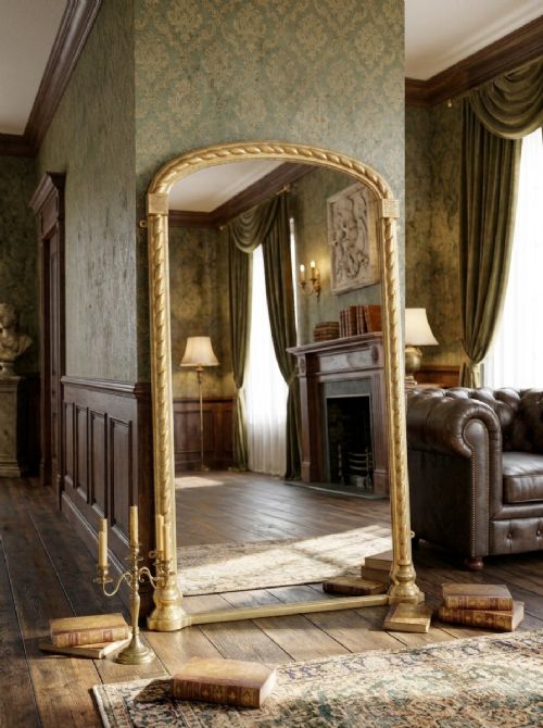 A tall arched gilded pier mirror featuring rope-twist carving, square corner block details, and reflective glass with light foxing. View XV