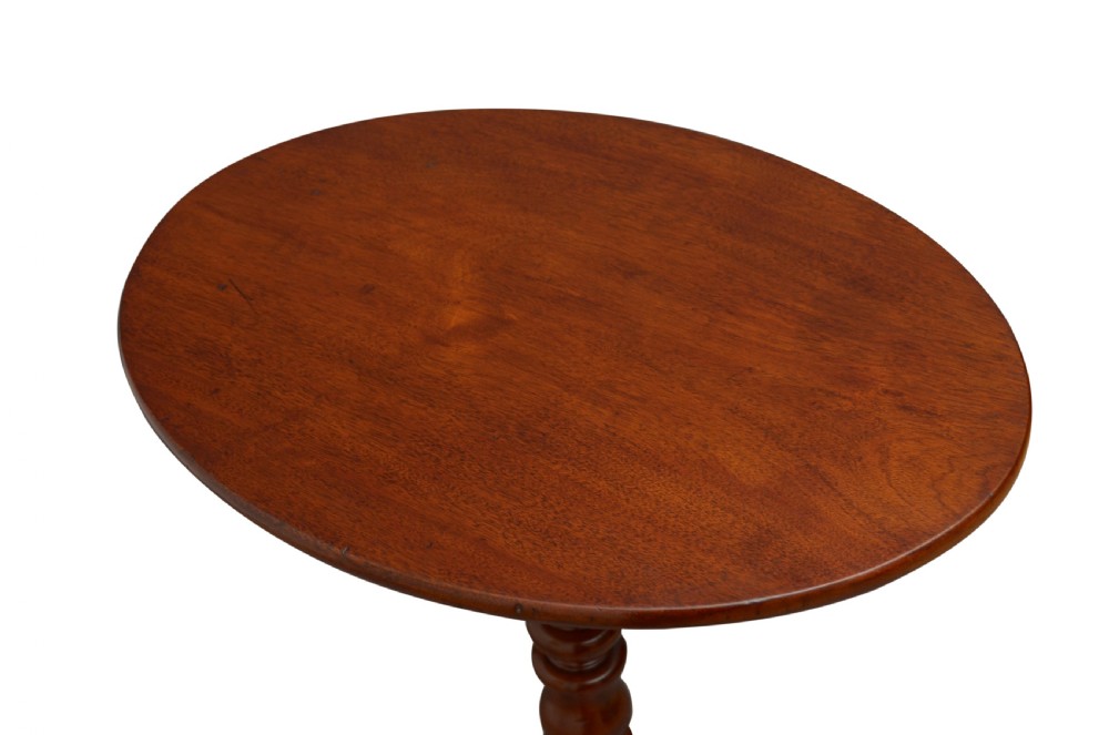 A Victorian mahogany circular tilt-top table featuring a turned central pedestal column resting on a tripod base. View II