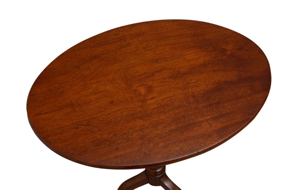 A Victorian mahogany circular tilt-top table featuring a turned central pedestal column resting on a tripod base. View III
