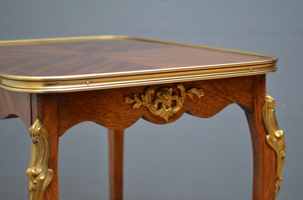 A rectangular two-tier wooden side table featuring inlaid veneers, curved cabriole legs, and ornate brass mounts. View II