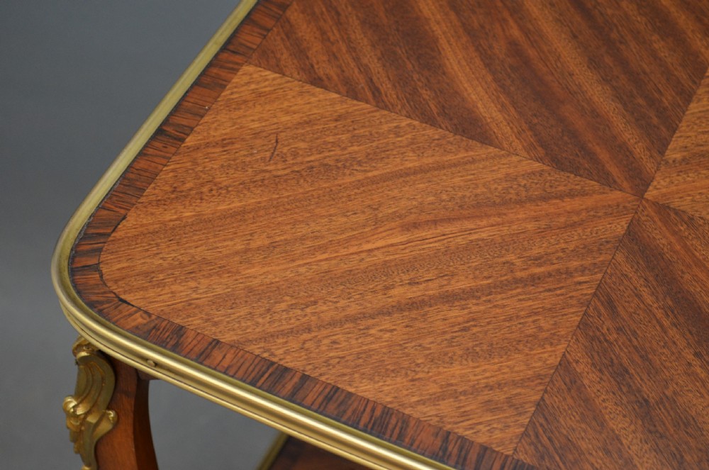 A rectangular two-tier wooden side table featuring inlaid veneers, curved cabriole legs, and ornate brass mounts. View V