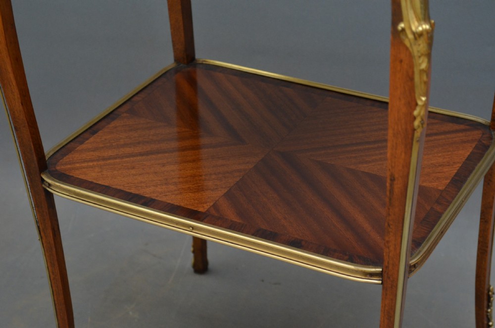 A rectangular two-tier wooden side table featuring inlaid veneers, curved cabriole legs, and ornate brass mounts. View VI