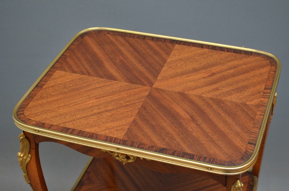 A rectangular two-tier wooden side table featuring inlaid veneers, curved cabriole legs, and ornate brass mounts. View VII