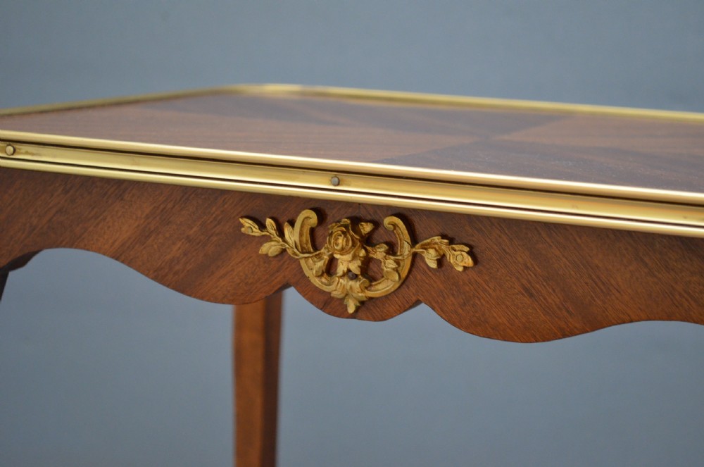 A rectangular two-tier wooden side table featuring inlaid veneers, curved cabriole legs, and ornate brass mounts. View VIII