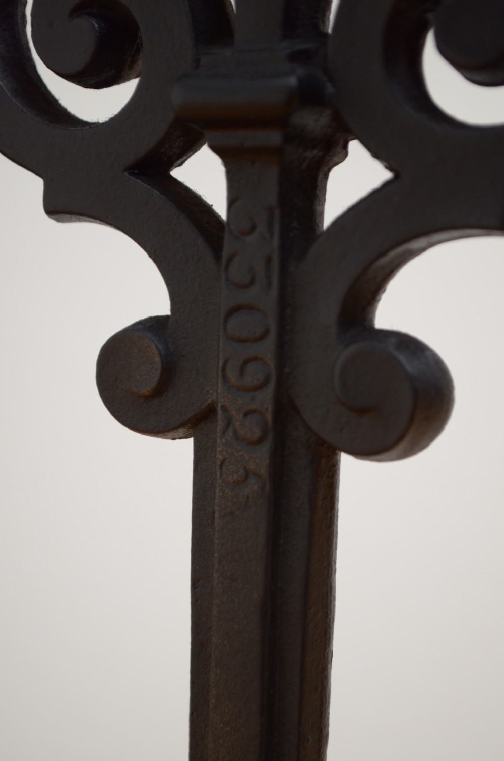 An ornate black cast iron umbrella and walking stick stand featuring openwork scroll panels, vertical pillars, and a compartmentalised base drip tray. View VI