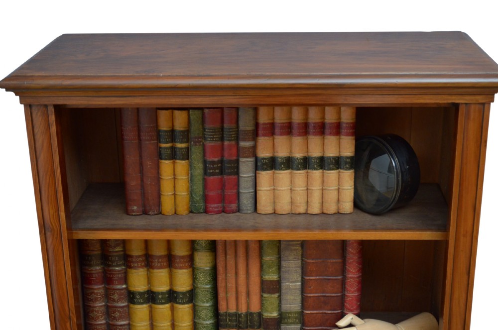 A low Victorian open bookcase crafted from walnut wood with three horizontal shelves. View X