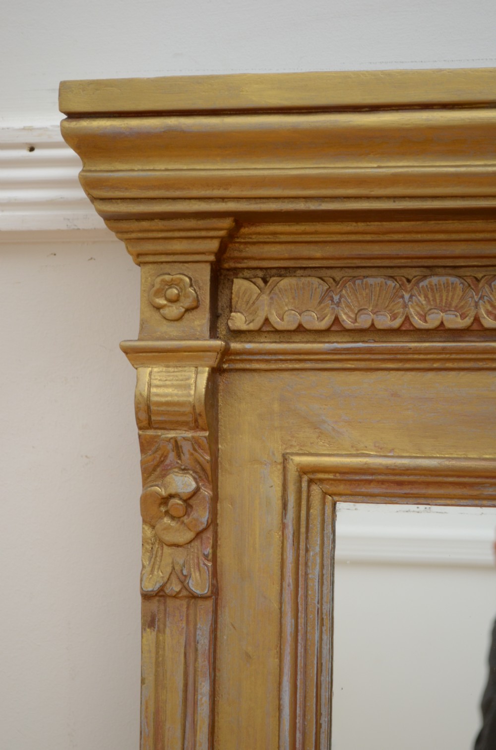 An upright Edwardian wall mirror featuring a carved wooden frame with gilt finish and decorative fluted pilasters. View VI