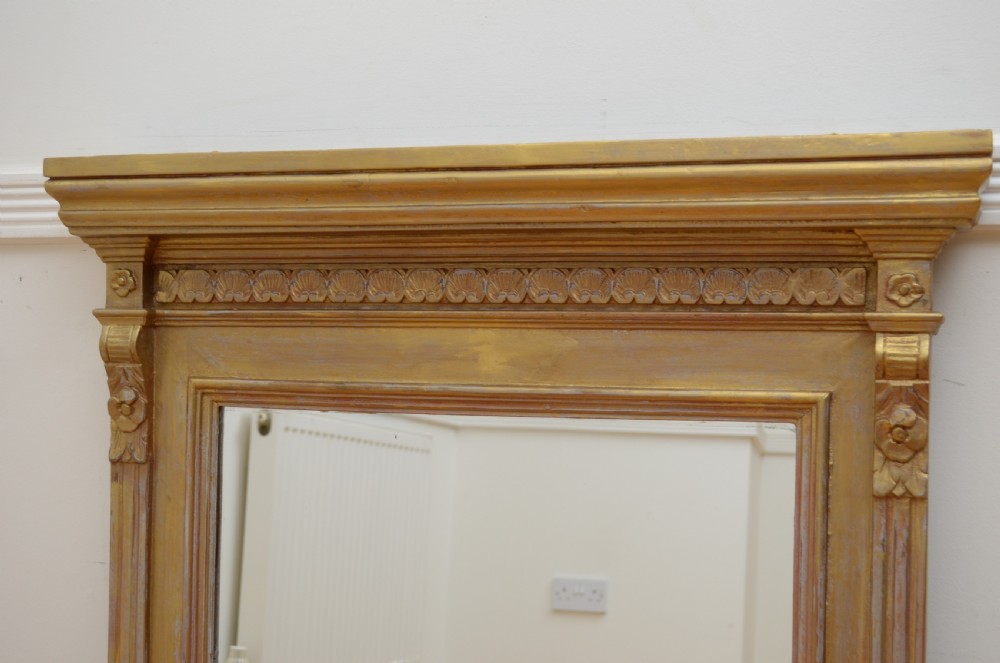 An upright Edwardian wall mirror featuring a carved wooden frame with gilt finish and decorative fluted pilasters. View VII