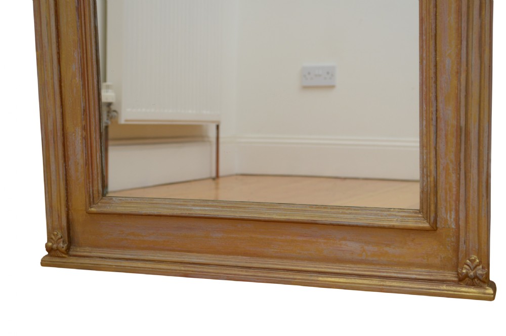 An upright Edwardian wall mirror featuring a carved wooden frame with gilt finish and decorative fluted pilasters. View XI
