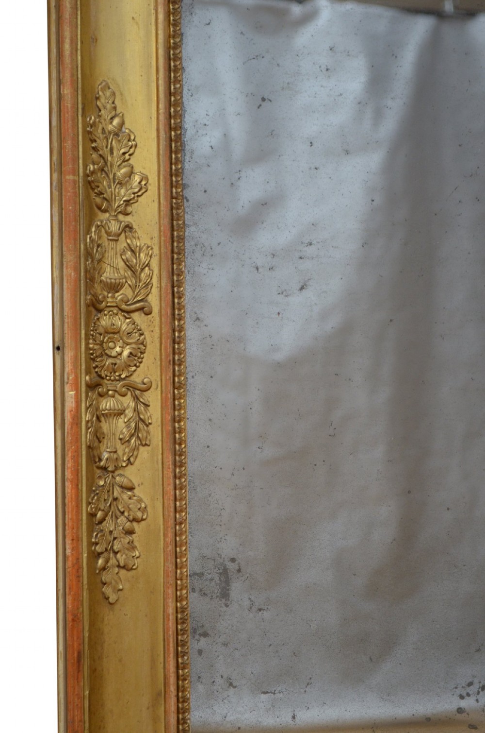 A rectangular Napoleonic giltwood wall mirror featuring detailed foliate low-relief carvings along the gilded frame. View III