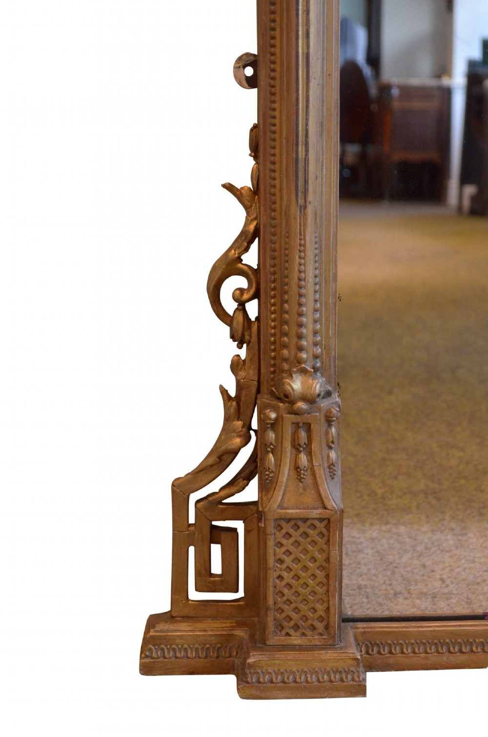 A large rectangular giltwood overmantel mirror featuring an arched top frame, carved cresting, side pilasters, and a gold finish. View VII
