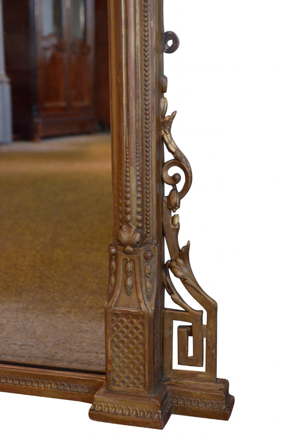 A large rectangular giltwood overmantel mirror featuring an arched top frame, carved cresting, side pilasters, and a gold finish. View XIII