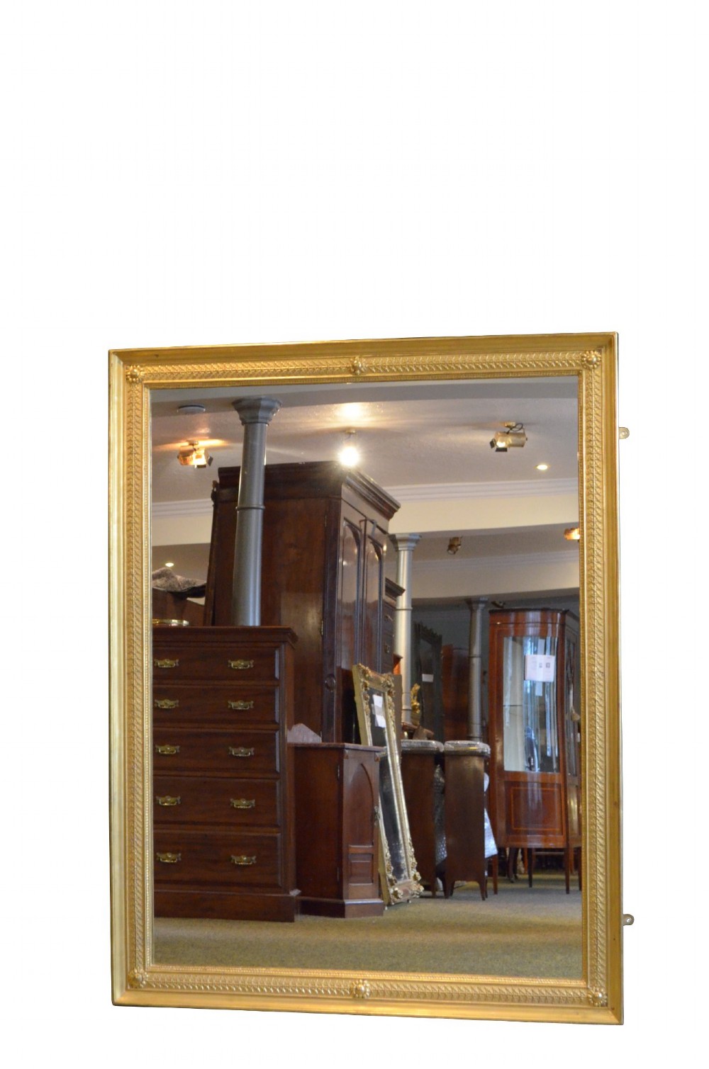 A large rectangular antique wall mirror featuring a carved giltwood frame decorated with detailed classical bead moulding and rosette bosses. View V