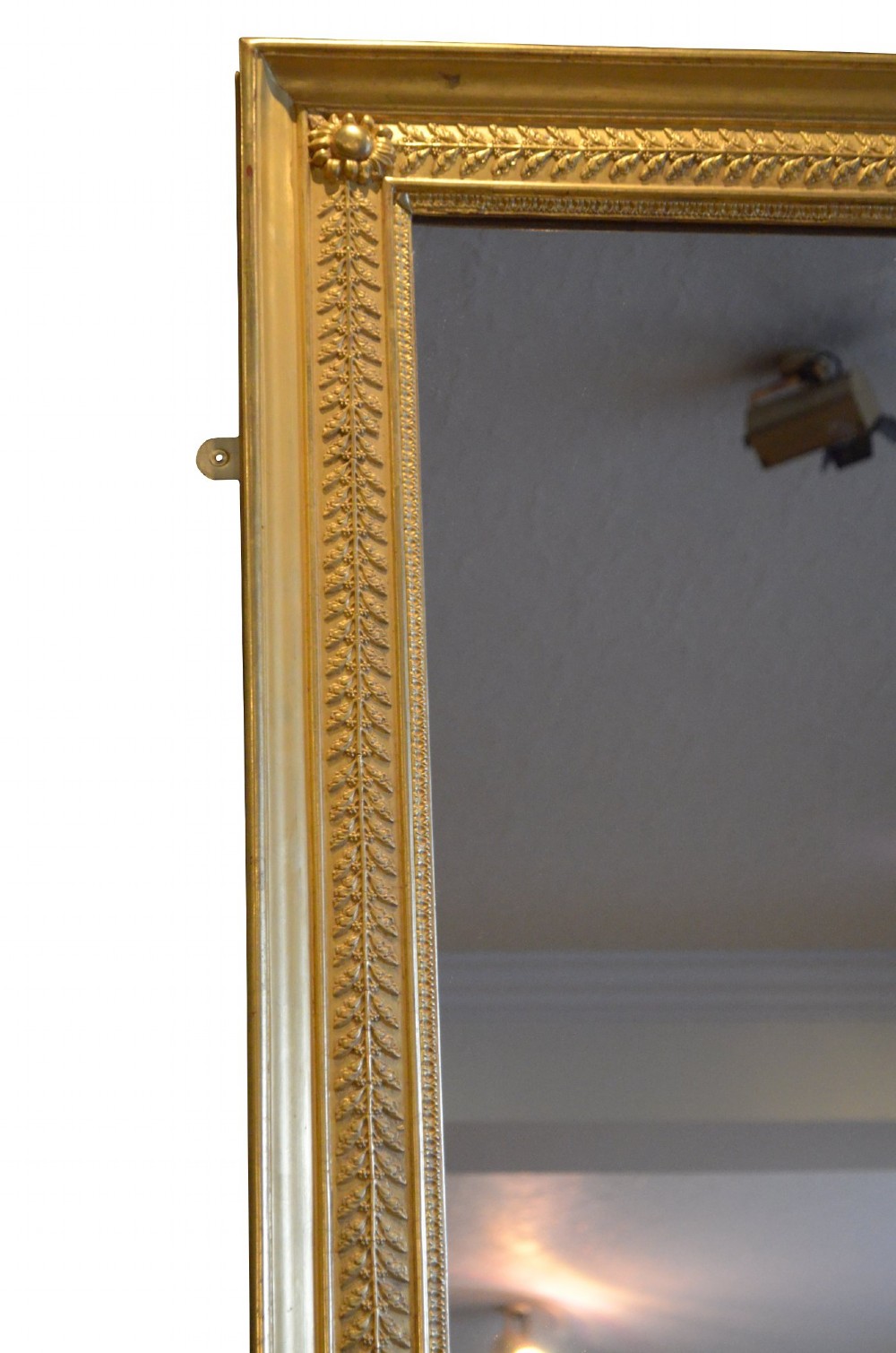 A large rectangular antique wall mirror featuring a carved giltwood frame decorated with detailed classical bead moulding and rosette bosses. View VII