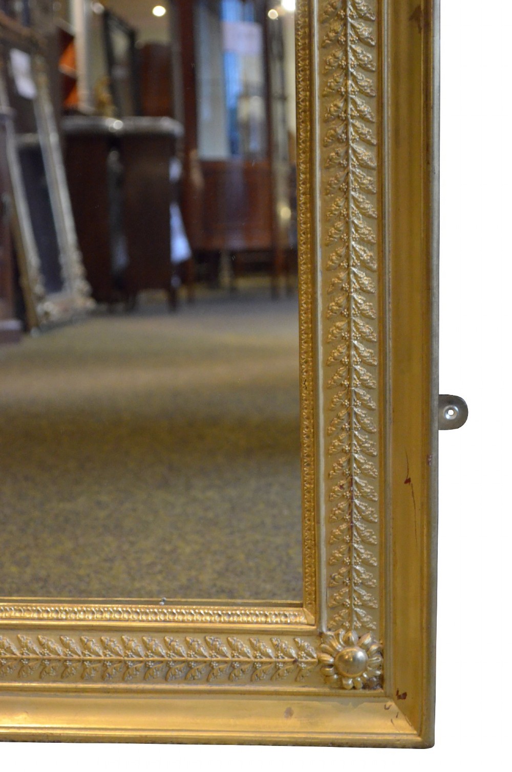 A large rectangular antique wall mirror featuring a carved giltwood frame decorated with detailed classical bead moulding and rosette bosses. View XI