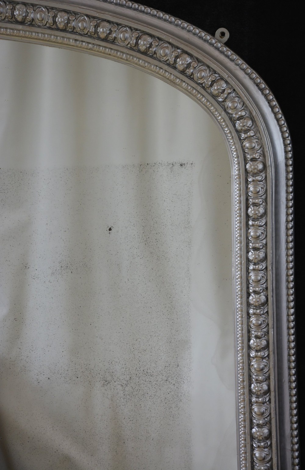 An arched Victorian silver-gilded overmantel mirror featuring beaded edge moulding along the frame. View III