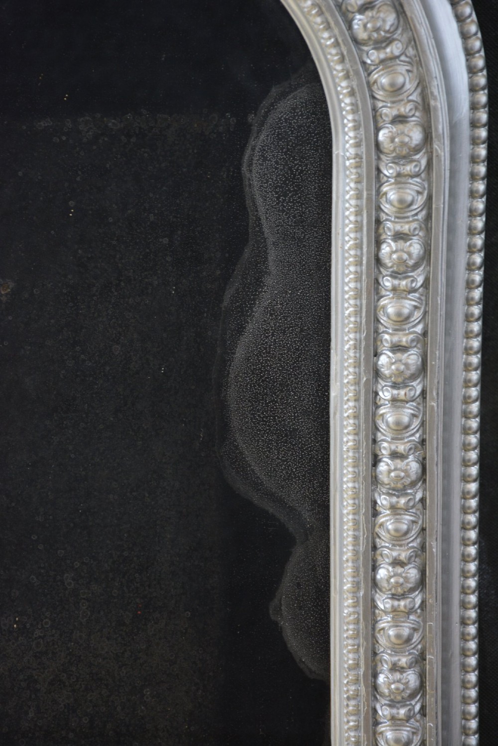 An arched Victorian silver-gilded overmantel mirror featuring beaded edge moulding along the frame. View IV