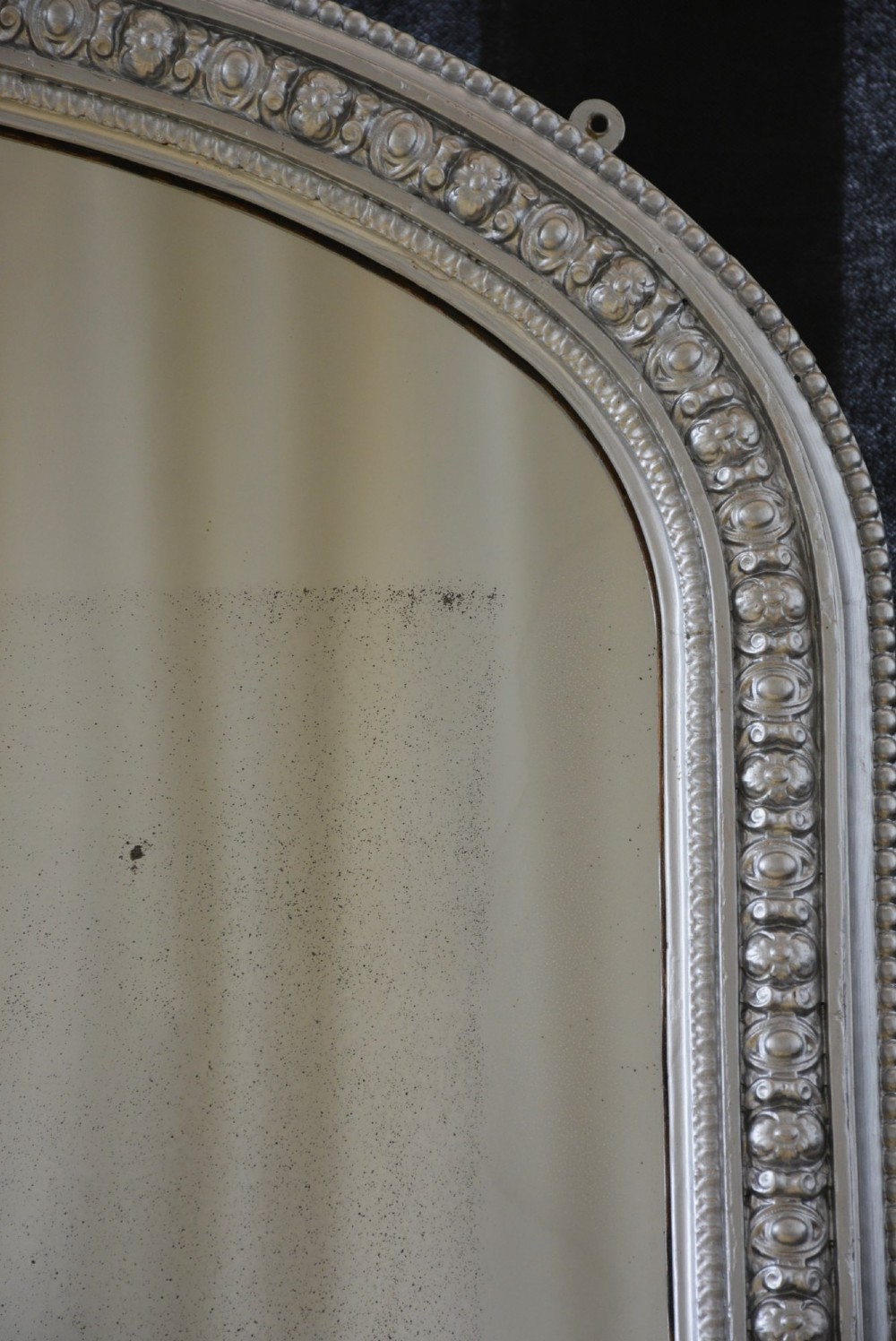 An arched Victorian silver-gilded overmantel mirror featuring beaded edge moulding along the frame. View V